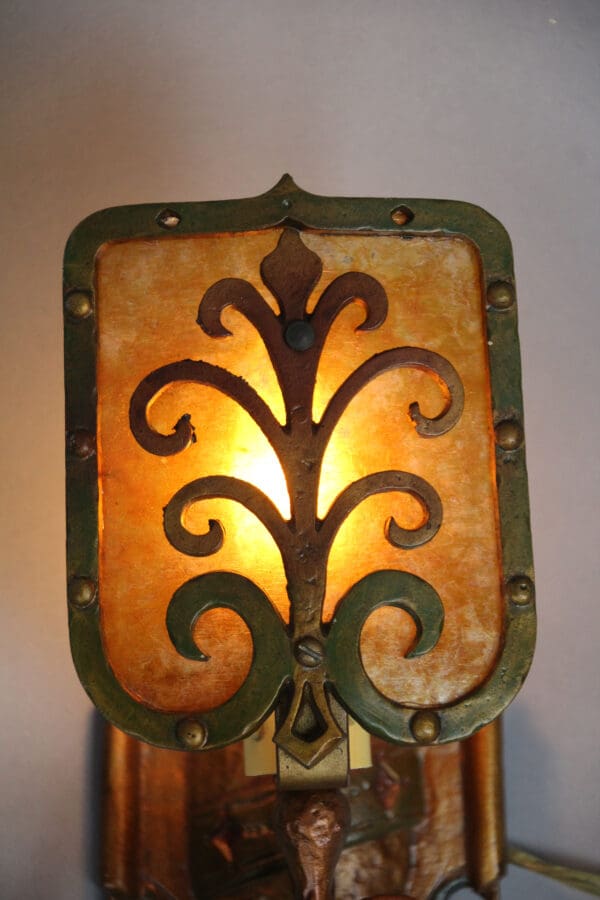 Vintage wall lamp with intricate design.