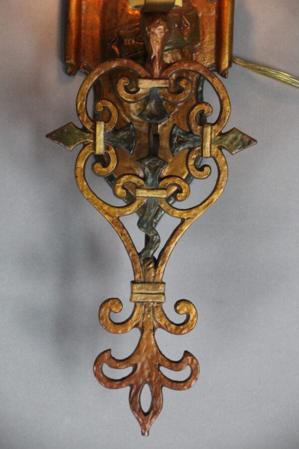 Ornate decorative wall fixture in bronze gold.