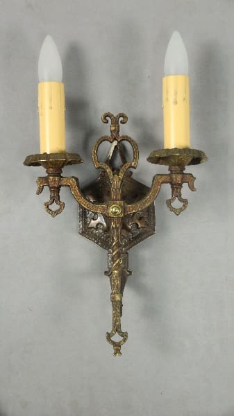 Antique wall sconce with two candles.