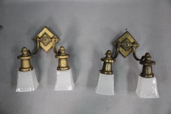 Vintage brass wall sconces with glass shades.