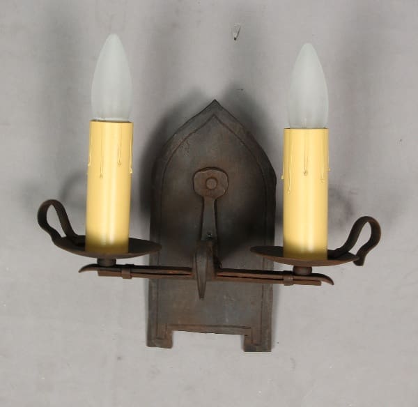 Wall-mounted candle holder with two lights.
