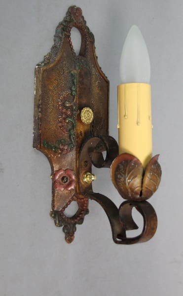 Vintage wall sconce with decorative design.