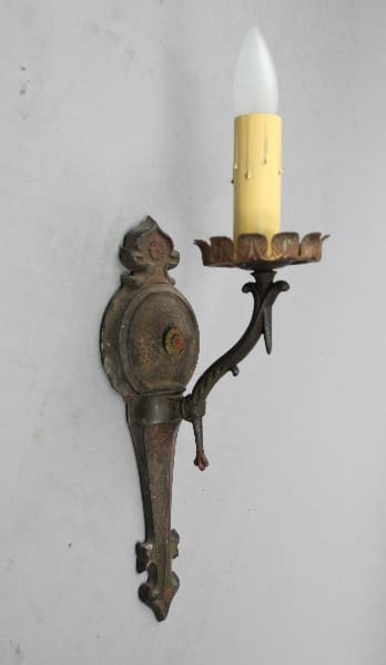 Wall-mounted antique candle holder with light.