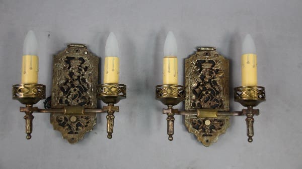 Bronze wall sconces with candle-like bulbs.