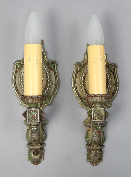 Antique wall sconces with candle-like bulbs.