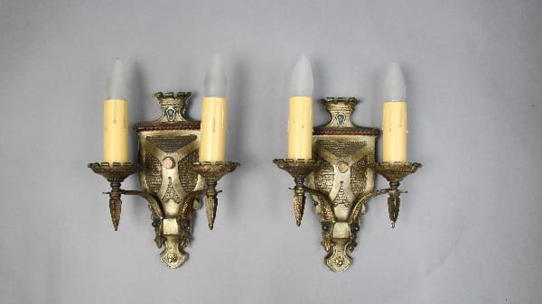 Two vintage wall sconces with candleholders.