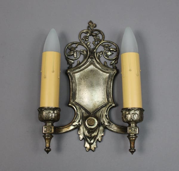 Vintage silver wall sconce with candles.