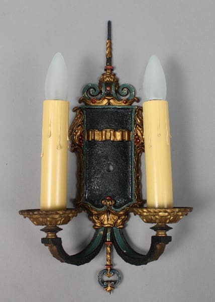 Vintage wall sconce with two candle holders.