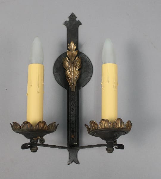 Wall-mounted candle holder with two candles.