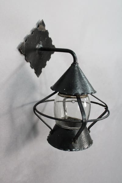Black metal wall lamp with glass shade.