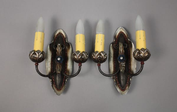 Two vintage wall sconces with candle-like bulbs.