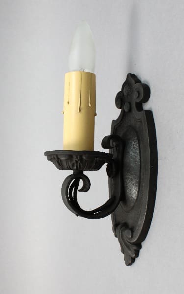 Wall-mounted candle holder with elegant design.