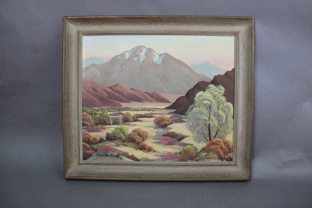 Mountain landscape painting in ornate frame.