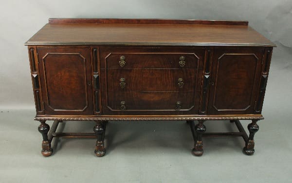 Wooden sideboard with intricate detailing and drawers.