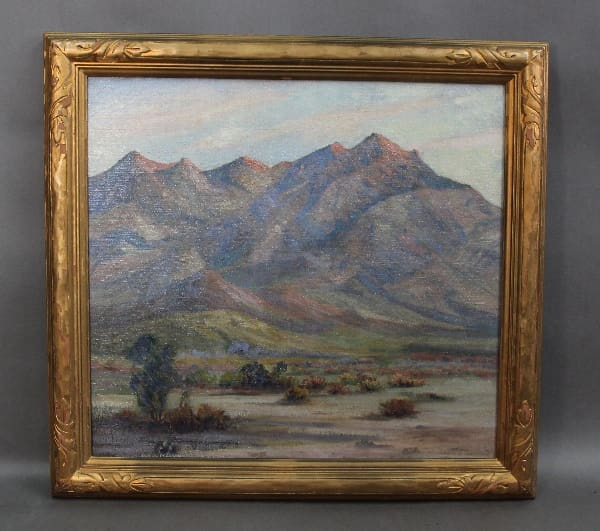 Framed painting of mountain landscape scene.