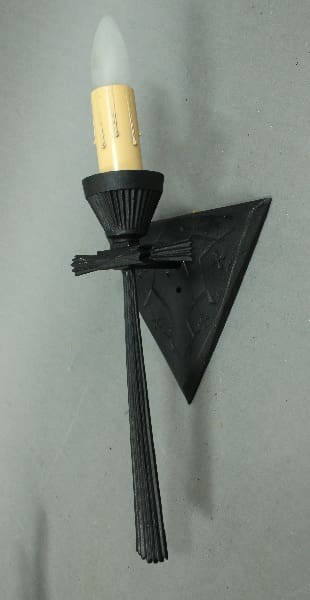 Black wall sconce with candle-style light.