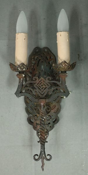 Antique wall sconce with two candle holders.