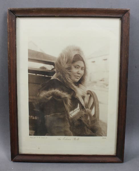 Framed sepia portrait of a young woman.