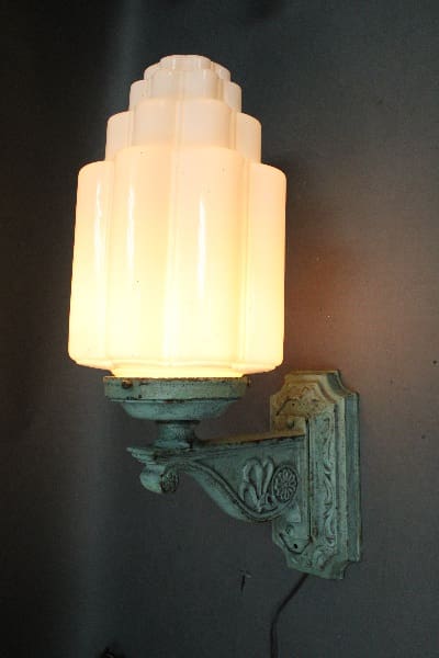 Art Deco wall sconce with frosted glass shade.