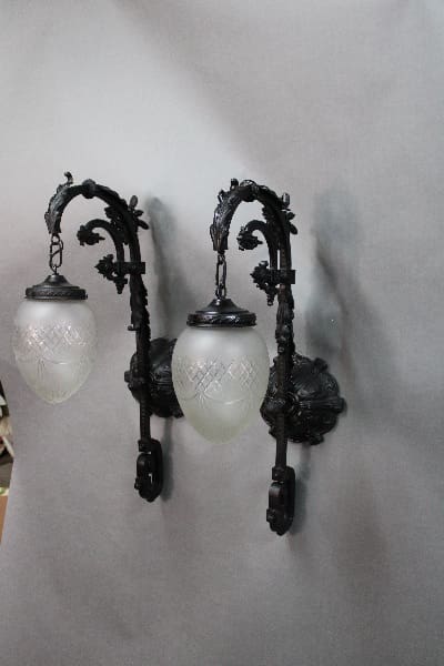 Vintage wall-mounted light fixtures with frosted globes.