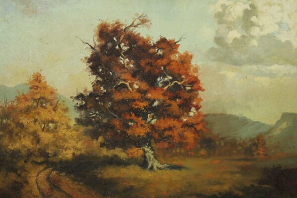Autumn landscape with a vibrant orange tree.