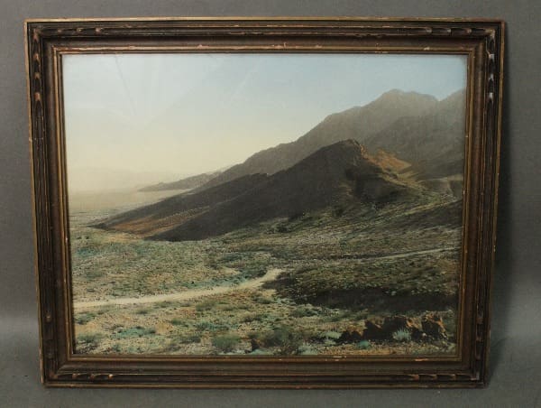 Mountain landscape with a winding dirt road.