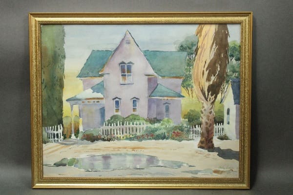 Pastel-colored house with surrounding greenery.