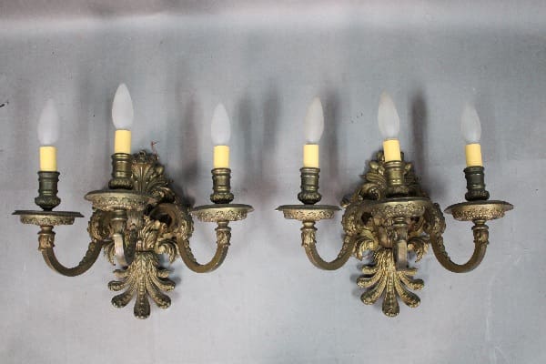 Two ornate wall sconces with candle-style lights.