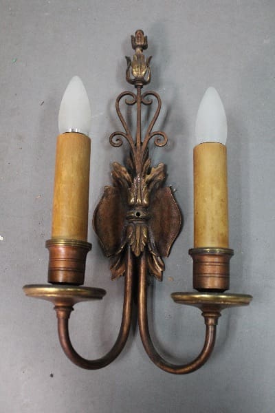 Vintage brass wall sconce with two bulbs.