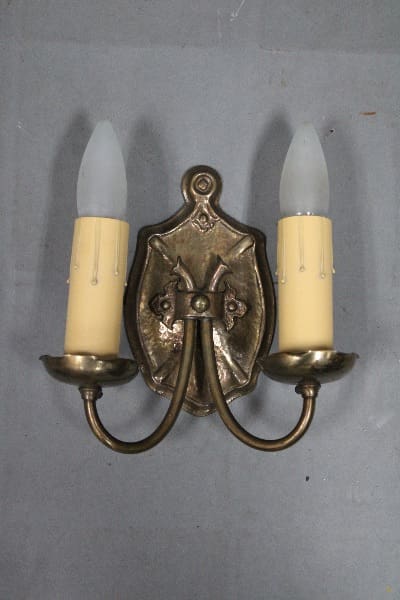 Vintage wall sconce with two candle holders.