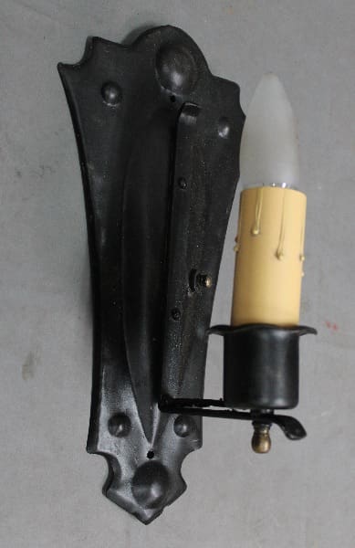 Wall-mounted candle holder with bulb.