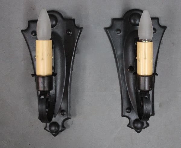 Two vintage wall sconces with candle bulbs.