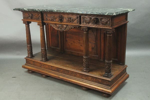 Ornate wooden console table with marble top.