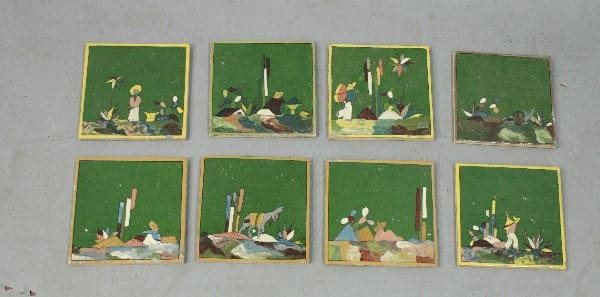 Eight framed paintings of green landscapes.