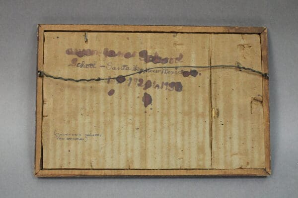 Back of a framed artwork with notes.