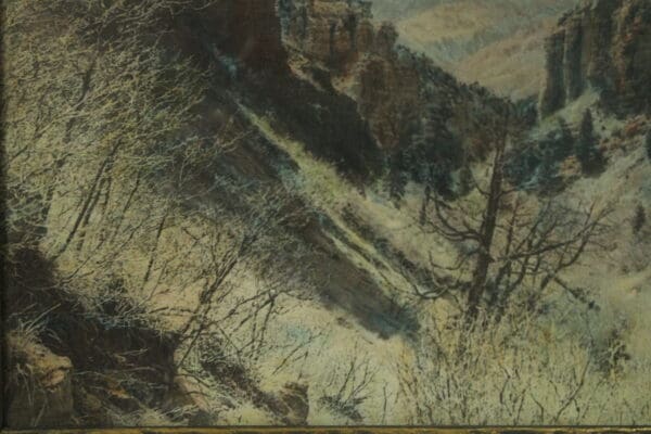 Mountain landscape with bare trees and hills.
