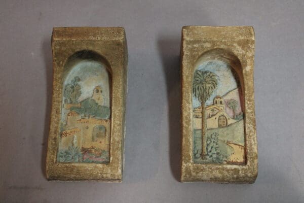 Two ceramic tiles with painted scenes.