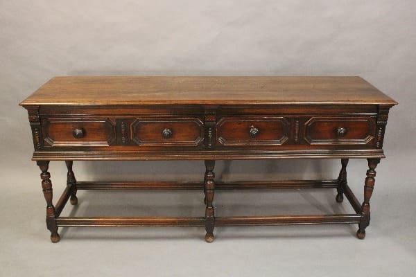 Antique wooden sideboard with three drawers.