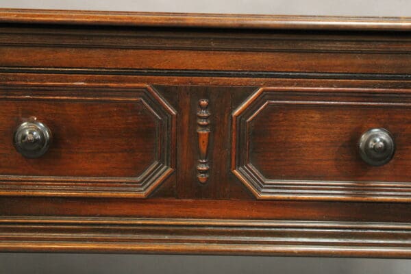 Wooden furniture drawer with ornate details.