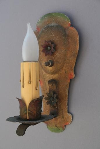 Vintage wall sconce with flower designs.