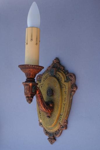 Vintage wall sconce with candle-style bulb.