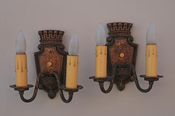 Antique-style wall sconces with candle-style lights.