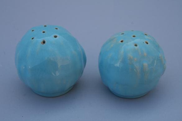 Two blue ceramic salt shakers.
