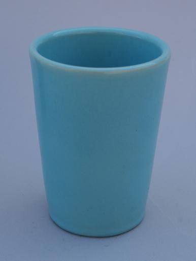 Light blue ceramic cup on white background.