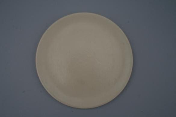 Plain round plate on a grey background.