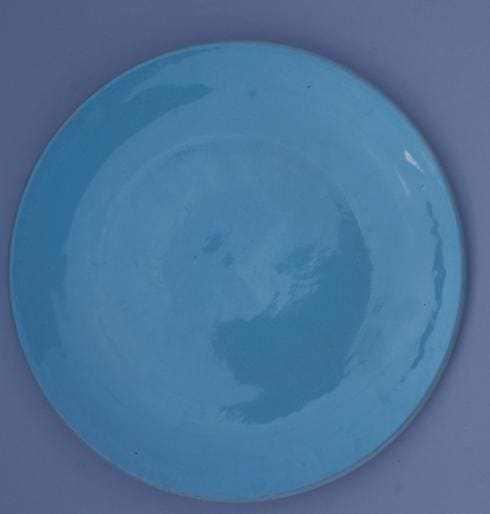 Blue ceramic plate on a gray background.