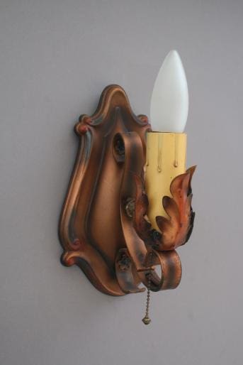Vintage wall sconce with decorative design.