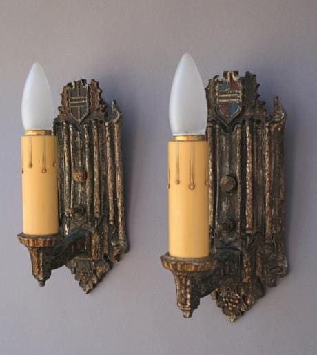 Two vintage wall sconces with candle lights.