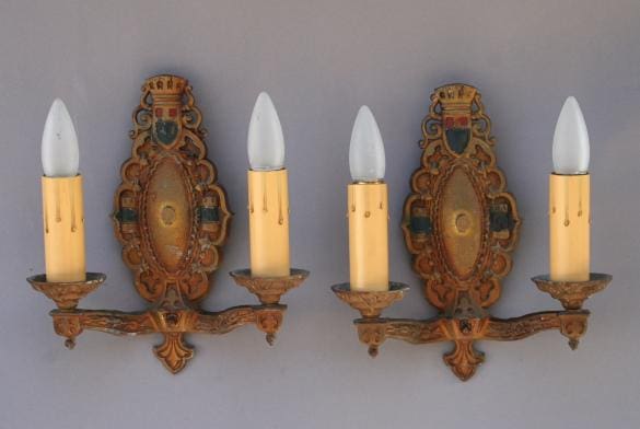 Ornate wall sconces with candle-like bulbs.