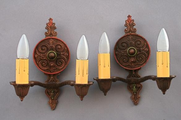 Ornate wall sconces with candle-like bulbs.